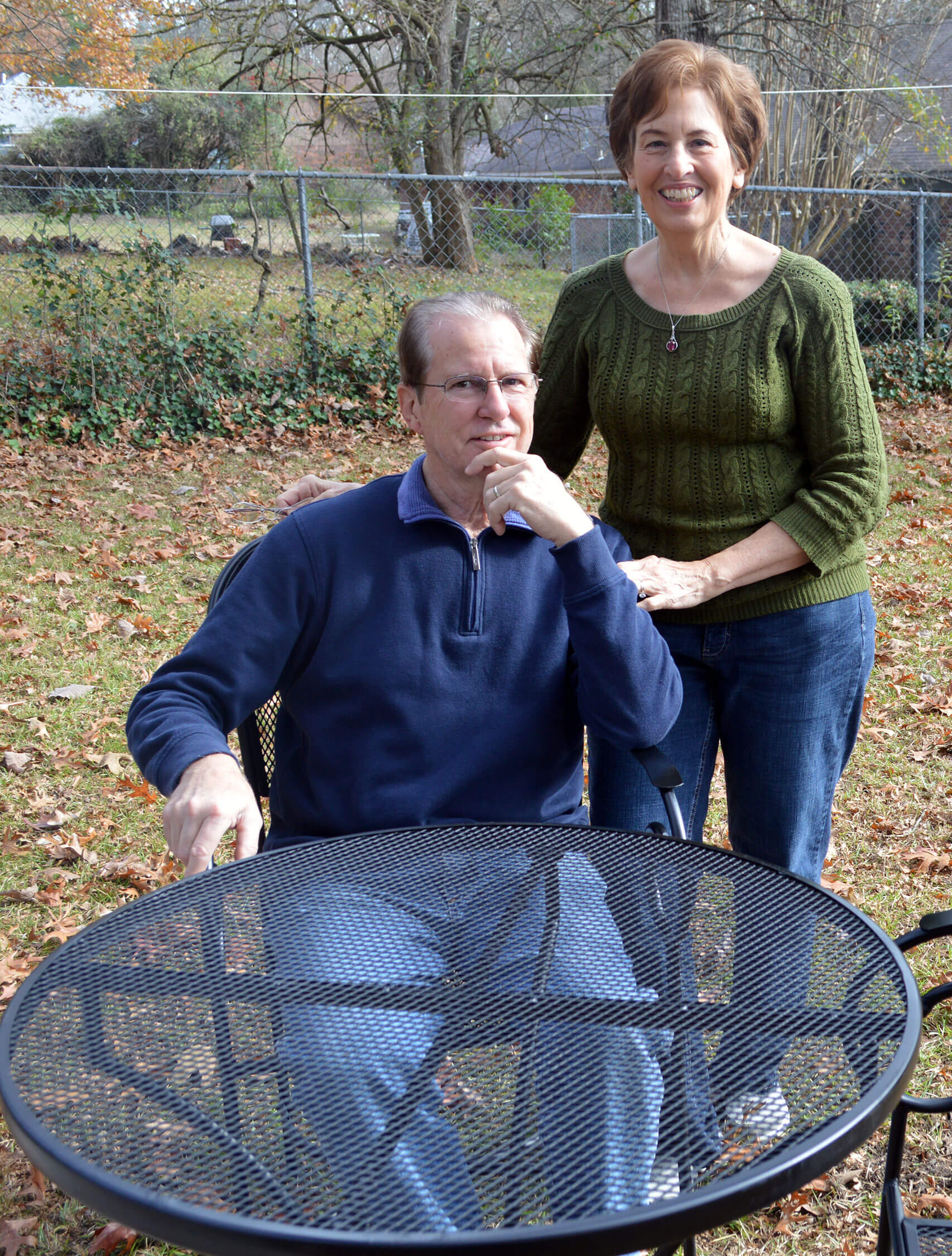 My parents with the newly refurbished table and chairs